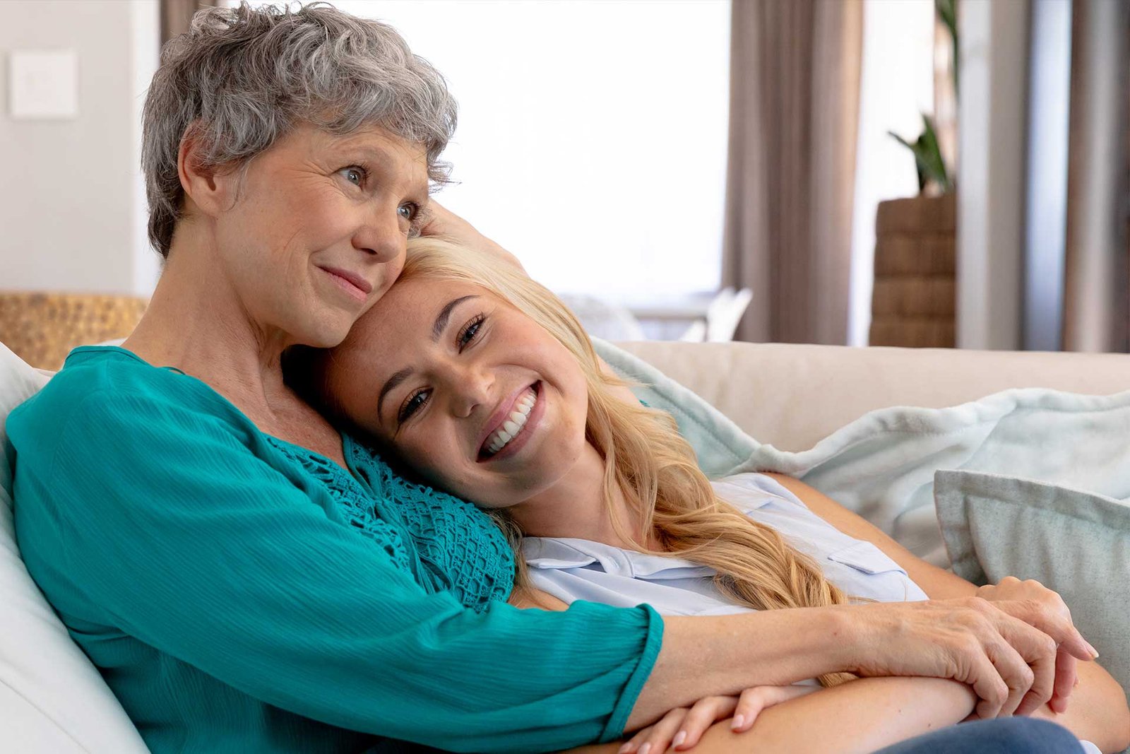 Caregiver and senior participant sharing a warm, joyful moment together