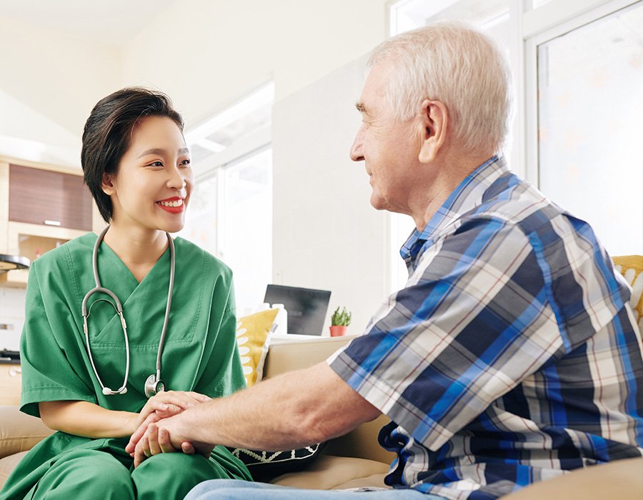 Companion Care Nurse Reassuring Senior Patient